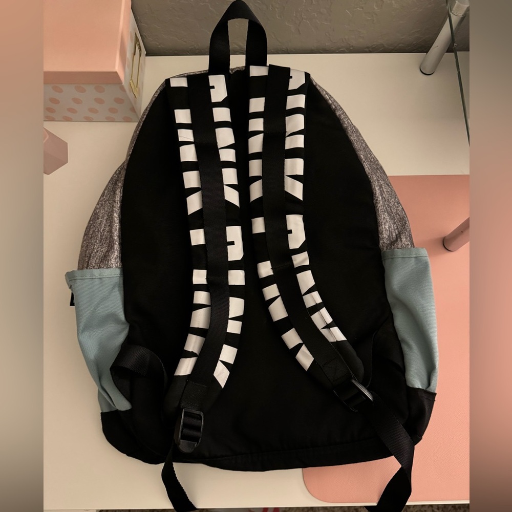 Backpack from PINK, it is a blue/green color with gray, black and white